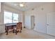 Bedroom area with a ceiling fan, office area, and window with shutters at 7667 E Krall St, Scottsdale, AZ 85250