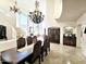 Grand dining room with high ceilings, elegant chandeliers, and tile floors at 7667 E Krall St, Scottsdale, AZ 85250