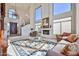 Bright living room with high ceilings, large windows, and a cozy fireplace at 7667 E Krall St, Scottsdale, AZ 85250