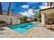 Backyard pool featuring a surrounding stone patio and privacy walls, and a blue sky at 7667 E Krall St, Scottsdale, AZ 85250