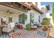 Inviting backyard patio with a ceiling fan, comfortable seating, stylish rug, and mature plants at 77 E Missouri Ave # 7, Phoenix, AZ 85012