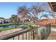 Picturesque balcony view of a serene pond, lush landscaping, and charming neighborhood at 77 E Missouri Ave # 7, Phoenix, AZ 85012