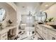 Spa-like bathroom featuring a soaking tub, modern fixtures, and stylish black and white flooring at 77 E Missouri Ave # 7, Phoenix, AZ 85012