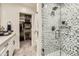 Bathroom showcasing modern shower with glass enclosure, vanity and walk-in closet at 77 E Missouri Ave # 7, Phoenix, AZ 85012