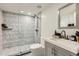 Modern bathroom featuring a glass shower with chevron tile, vanity, and neutral color palette at 77 E Missouri Ave # 7, Phoenix, AZ 85012