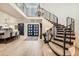 Grand entryway with curved staircase, elegant chandelier, and light wood floors creates a welcoming ambiance at 77 E Missouri Ave # 7, Phoenix, AZ 85012