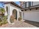 Charming home exterior showcasing an arched doorway, a private balcony, and a two car garage at 77 E Missouri Ave # 7, Phoenix, AZ 85012