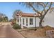 Exterior view of the home featuring a red tile roof, light post, and mature landscaping at 77 E Missouri Ave # 7, Phoenix, AZ 85012