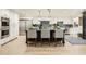 Bright, open kitchen with bar seating, updated appliances, modern lighting, and white cabinets at 77 E Missouri Ave # 7, Phoenix, AZ 85012
