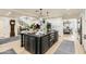 Kitchen boasts a center island with bar seating, updated appliances, and modern lighting fixtures at 77 E Missouri Ave # 7, Phoenix, AZ 85012