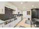 White cabinets and stainless steel appliances complement the black mosaic backsplash at 77 E Missouri Ave # 7, Phoenix, AZ 85012