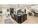 Open kitchen with a center island, custom cabinets, a staircase, and hardwood floors at 77 E Missouri Ave # 7, Phoenix, AZ 85012
