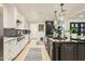 Bright kitchen featuring a center island, mosaic backsplash, and stainless steel appliances at 77 E Missouri Ave # 7, Phoenix, AZ 85012
