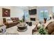 Cozy living room with a stone fireplace, wood floors, and plantation shutters at 77 E Missouri Ave # 7, Phoenix, AZ 85012