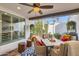 Covered patio with comfortable seating, ceiling fan, stylish rug, and view of the landscaped backyard at 77 E Missouri Ave # 7, Phoenix, AZ 85012