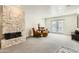Cozy sitting area with a stone fireplace, comfortable chairs, and ample natural light at 77 E Missouri Ave # 7, Phoenix, AZ 85012