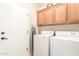 The laundry room is equipped with a washer, dryer, and cabinets at 81 W Sundance Ct, San Tan Valley, AZ 85143