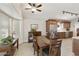 Bright dining area featuring wood floors, a ceiling fan, and lots of natural light at 8354 E Emelita Ave, Mesa, AZ 85208