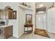 Grand entryway with high ceilings, neutral walls, decorative shelves, and light grey laminate wood flooring at 8354 E Emelita Ave, Mesa, AZ 85208