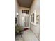 Inviting entryway featuring secure screen door, neutral tones, and a cozy seating area at 8354 E Emelita Ave, Mesa, AZ 85208