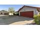 View of the home's red-brown garage door and rock landscaping showing desert charm at 8354 E Emelita Ave, Mesa, AZ 85208