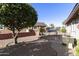 Well maintained front yard featuring trees, gravel, and view of street at 8354 E Emelita Ave, Mesa, AZ 85208