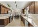 Modern open-concept kitchen featuring stainless steel appliances and laminate wood flooring at 8354 E Emelita Ave, Mesa, AZ 85208