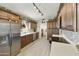 Modern kitchen featuring stainless steel appliances, dark wood cabinets, and stylish backsplash at 8354 E Emelita Ave, Mesa, AZ 85208