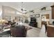 Spacious open-concept living area with lots of natural light, vaulted ceiling and laminate wood floors at 8354 E Emelita Ave, Mesa, AZ 85208