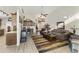 Cozy open-concept living area with laminate floors, neutral walls, and comfortable furnishings at 8354 E Emelita Ave, Mesa, AZ 85208