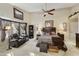 Inviting main bedroom boasts ample space, a ceiling fan, and comfortable seating area at 8354 E Emelita Ave, Mesa, AZ 85208