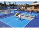 Active pickleball game in progress on well-maintained courts, with a scenic pond in the background at 8354 E Emelita Ave, Mesa, AZ 85208