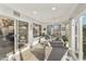 Bright sunroom with sliding glass doors, tile flooring, ceiling fan, and ample natural light at 8354 E Emelita Ave, Mesa, AZ 85208