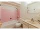 Charming bathroom with pink tile, vanity sink and a shower-tub combo at 8648 N 37Th Ave, Phoenix, AZ 85051