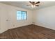 Bright bedroom featuring wood-look floors and a large window for ample natural light at 8648 N 37Th Ave, Phoenix, AZ 85051