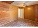 Spacious bedroom featuring wood-look floors and wood paneled walls with natural light at 8648 N 37Th Ave, Phoenix, AZ 85051