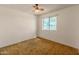 Bright bedroom featuring a ceiling fan and a window letting in natural light at 8648 N 37Th Ave, Phoenix, AZ 85051