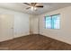 Spacious bedroom featuring wood-look floors and a large window for ample natural light at 8648 N 37Th Ave, Phoenix, AZ 85051
