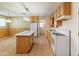 Kitchen with island, white appliances, and adjoined laundry room at 8648 N 37Th Ave, Phoenix, AZ 85051