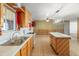 Kitchen features a double basin sink, white appliances, and adjoins a large living space at 8648 N 37Th Ave, Phoenix, AZ 85051