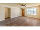 Spacious living room featuring wood-look floors and a large front-facing window for ample natural light at 8648 N 37Th Ave, Phoenix, AZ 85051