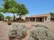 Vast backyard with desert landscaping, mature vegetation and home's covered patios at 9437 E Champagne Dr, Sun Lakes, AZ 85248
