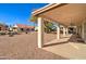 Covered patio and landscaped backyard with gravel at 9437 E Champagne Dr, Sun Lakes, AZ 85248