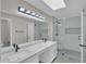 Bright bathroom featuring double sinks, modern fixtures, a glass shower, and neutral color palette at 9437 E Champagne Dr, Sun Lakes, AZ 85248