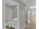 Neutral bathroom with modern white vanity and a light-colored counter, along with an adjacent doorway at 9437 E Champagne Dr, Sun Lakes, AZ 85248