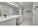 Updated bathroom featuring a double vanity and walk-in shower with modern black fixtures at 9437 E Champagne Dr, Sun Lakes, AZ 85248