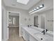 Bathroom with a double sink vanity, quartz countertop, modern fixtures, and a large mirror at 9437 E Champagne Dr, Sun Lakes, AZ 85248