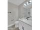Bathroom with white vanity, sink, quartz countertop, black fixtures, and modern lighting at 9437 E Champagne Dr, Sun Lakes, AZ 85248