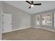 Bedroom features neutral walls, wood floors, a ceiling fan, and windows with plantation shutters at 9437 E Champagne Dr, Sun Lakes, AZ 85248