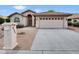 Charming single-story home with a desert landscape and a spacious two-car garage at 9437 E Champagne Dr, Sun Lakes, AZ 85248